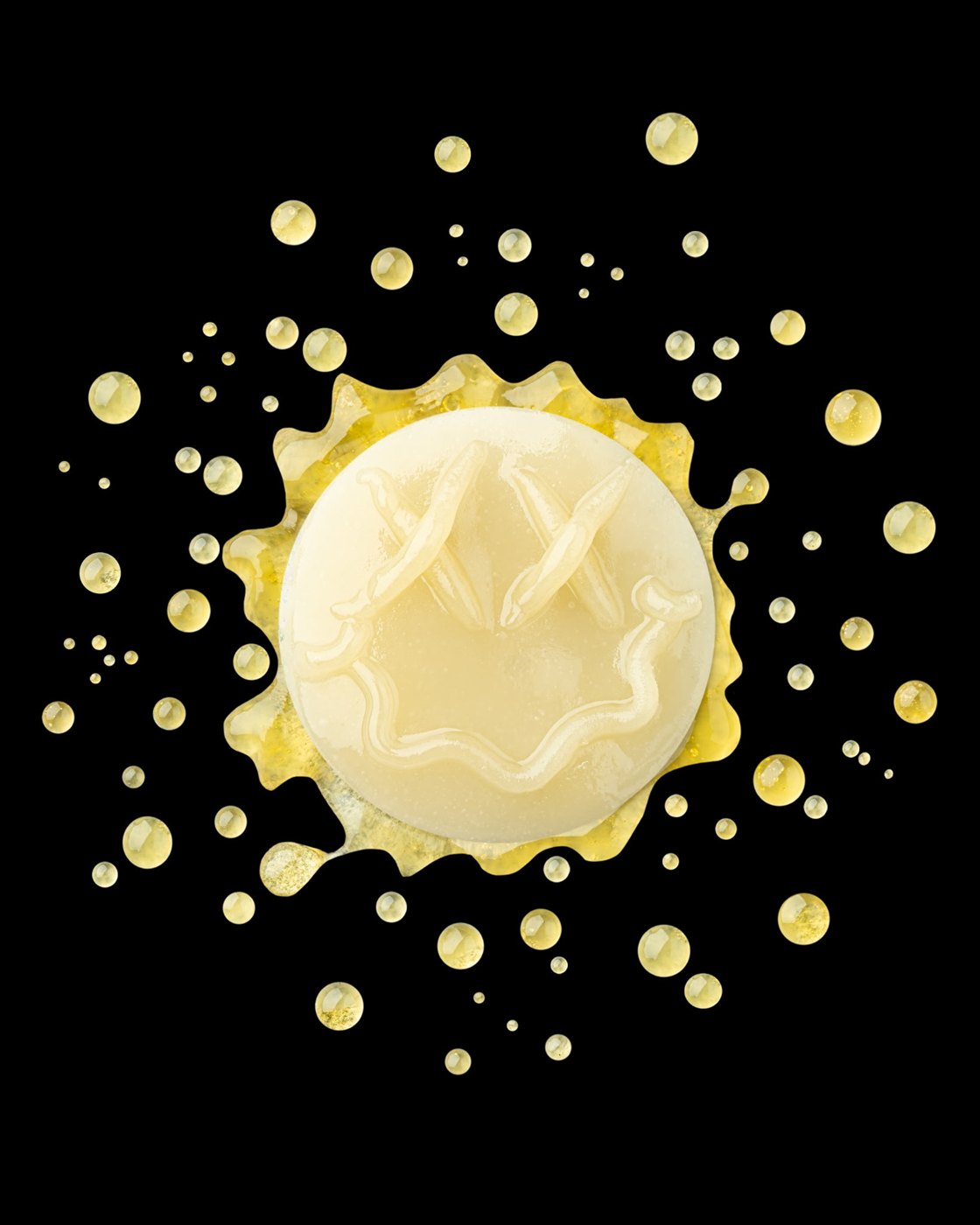 Smiley-shaped rosin with golden droplets
