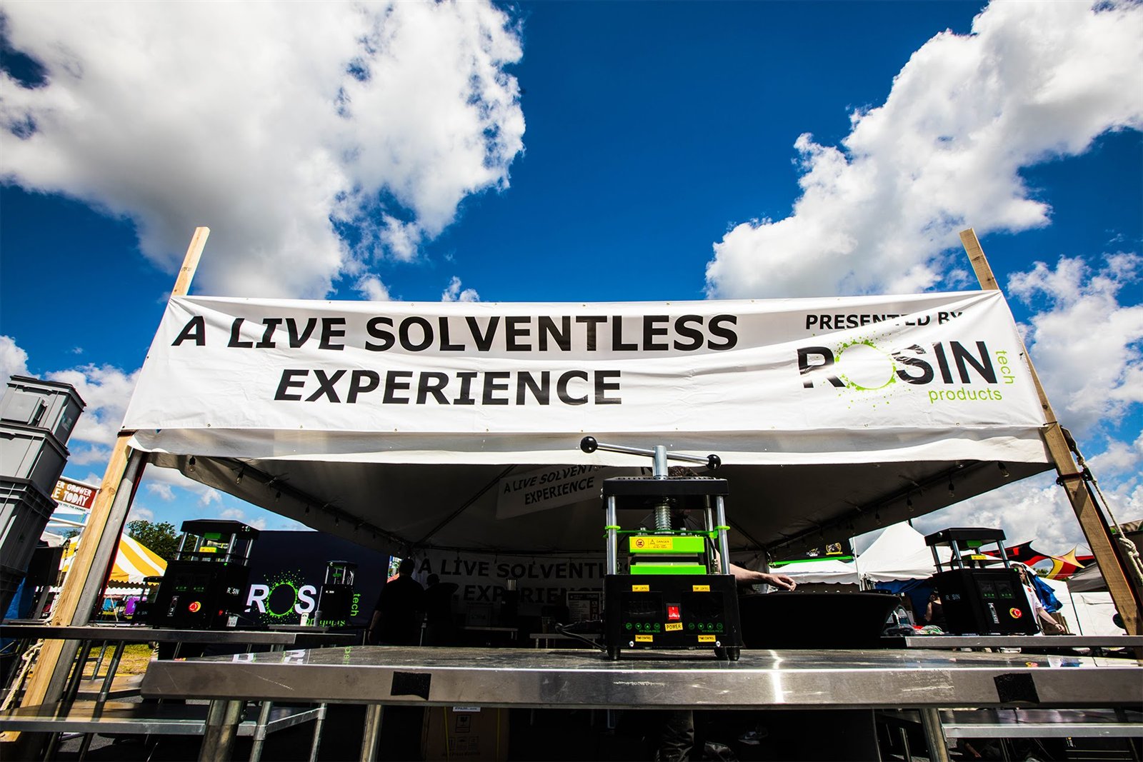 A Live Solventless Experience event booth with a Rosin Tech press